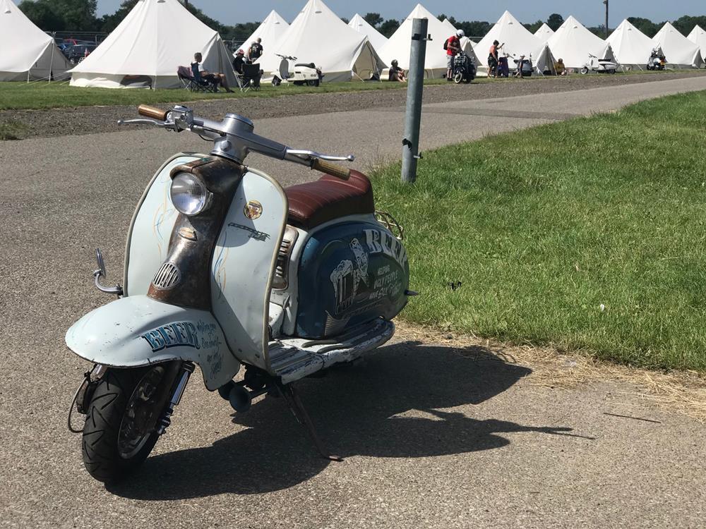 Lambretta in front of yurts at the Big 7 scooter rally